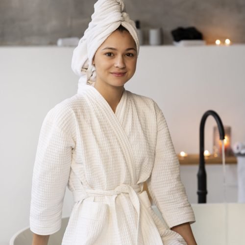 young-woman-sitting-by-bathtub-before-taking-bath